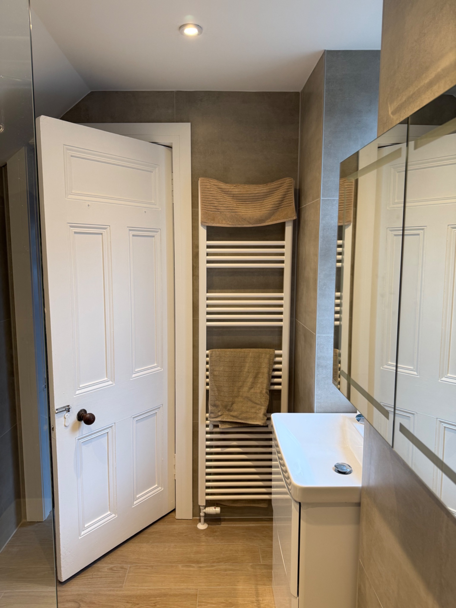 Finished bathroom suite in Coatbridge with new basin unit, mirrored cabinet and heated towel rail