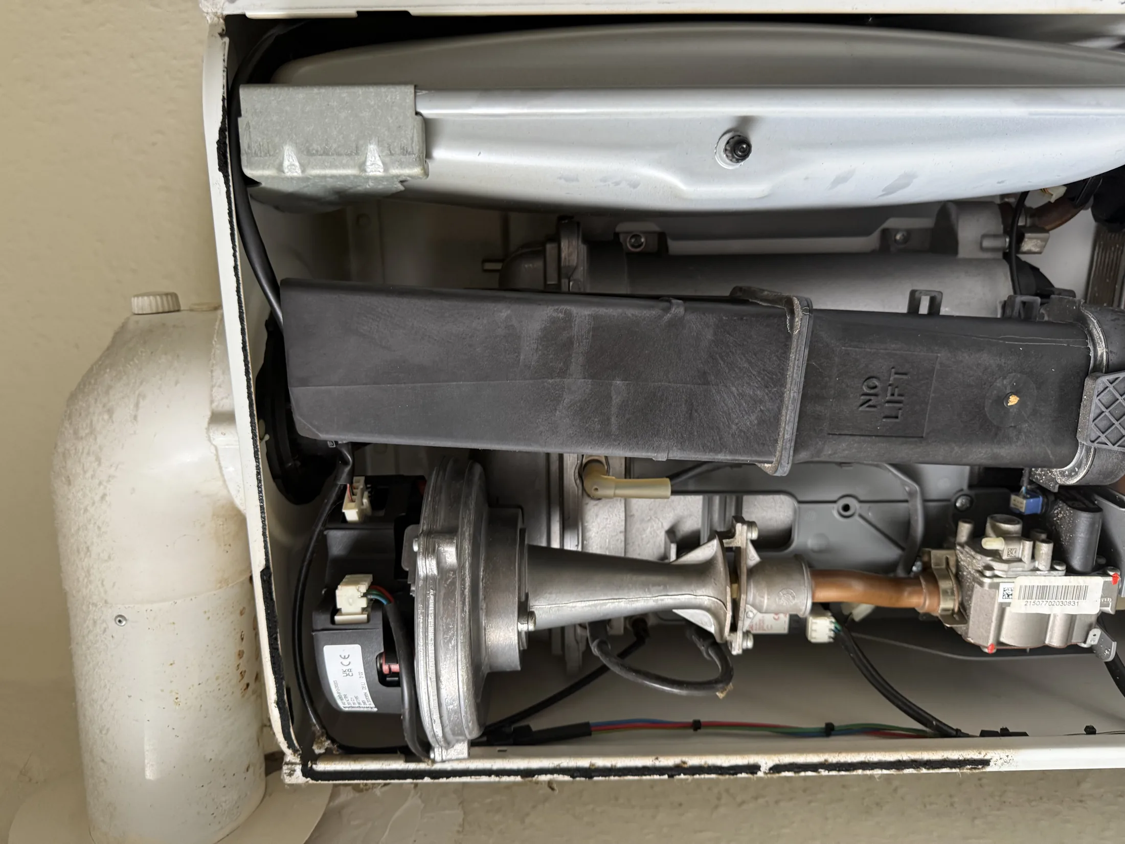Gas Safe engineer repairing combi boiler