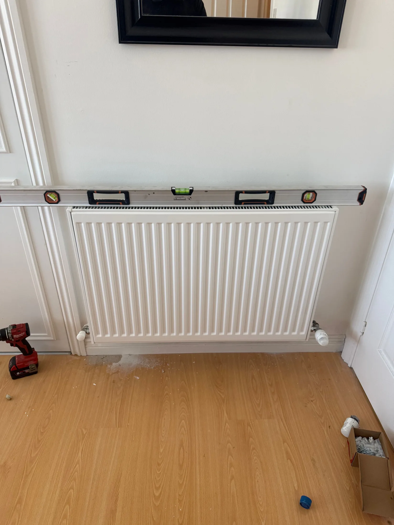 Panel radiator levelled and fitted during a Glasgow installation
